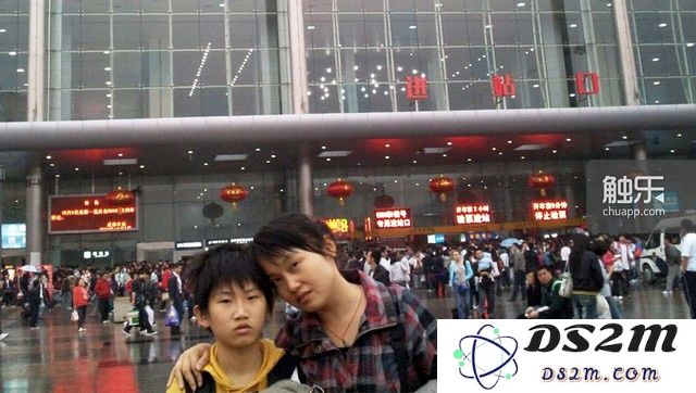12岁的砍砍与母亲在火车站前的合影。父母离异后,砍砍跟随母亲长大